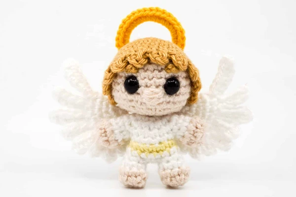 A miniature crochet angel doll.
