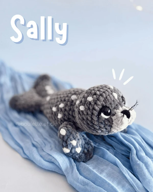 Dark grey spotted seal plushie.
