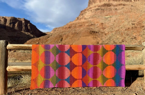 A brightly coloured star and moon motif blanket.