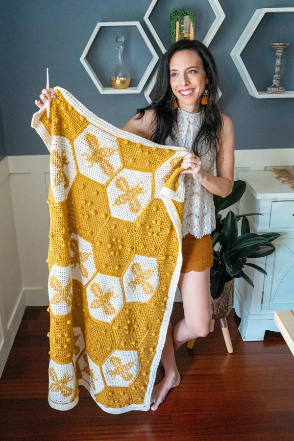 A hexagon blanket with bee-motifs worked in tapestry crochet.