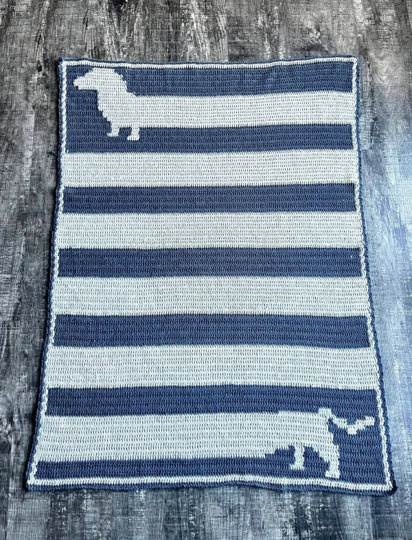 A striped sausage dog motif blanket.