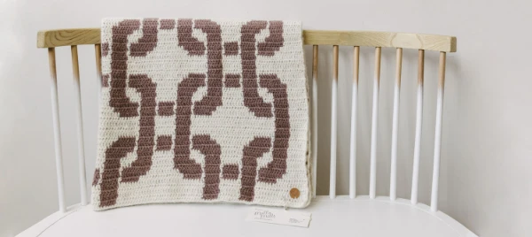 A Morrocan-inspired geometric tapestry crochet blanket.