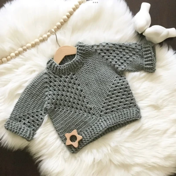 A grey crocheted baby sweater constructed from granny hexagons.