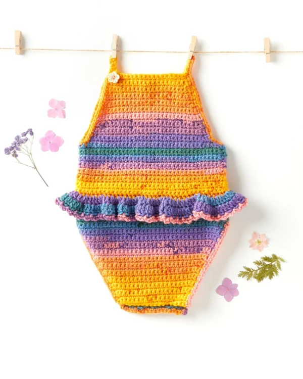 A simple, sleeveless crochet  baby onesie with ruffle detail.