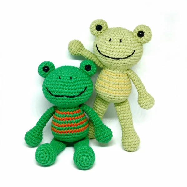 Crochet frogs with striped bellies.