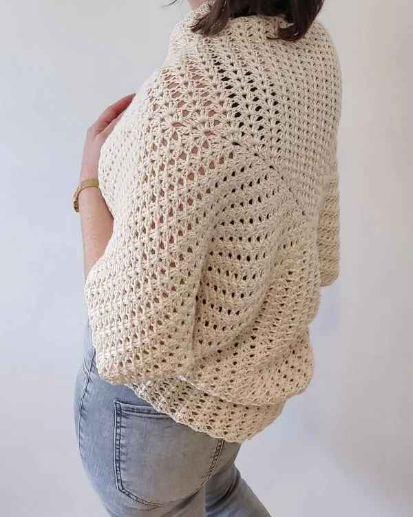 Back view of a cream coloured granny square shrug.