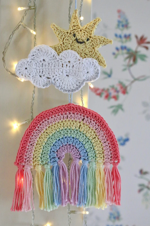 A crochet rainbow wall hanging for a nursery.