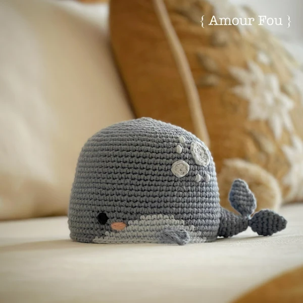 Grey crochet whale toy.