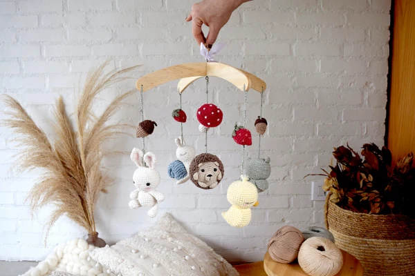 A crochet baby mobile with woodland animals.