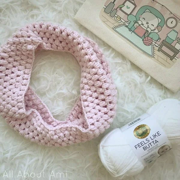 A pale pink child sized crochet cowl.