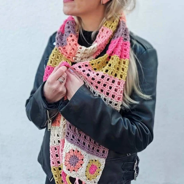 A lightweight crochet granny square scarf with mesh stitch sections.