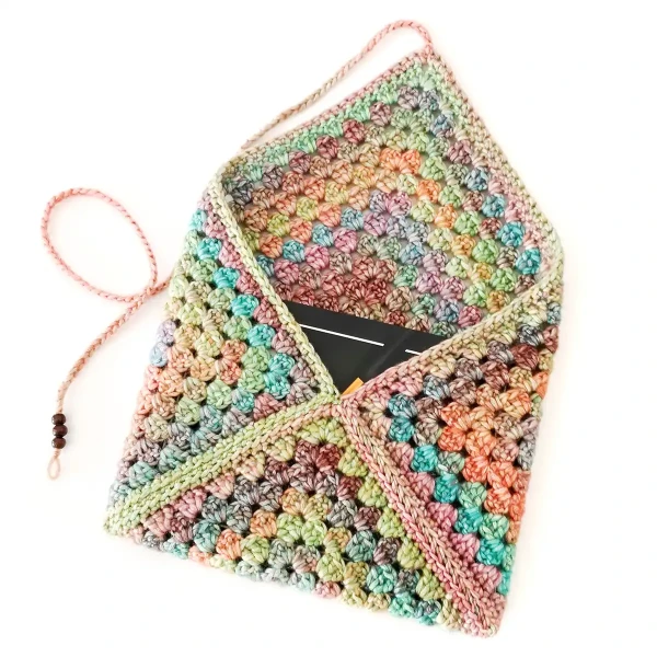 A crochet book sleeve made from one big granny square.
