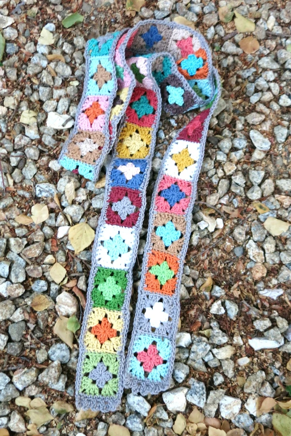 A granny square crochet skinny scarf.