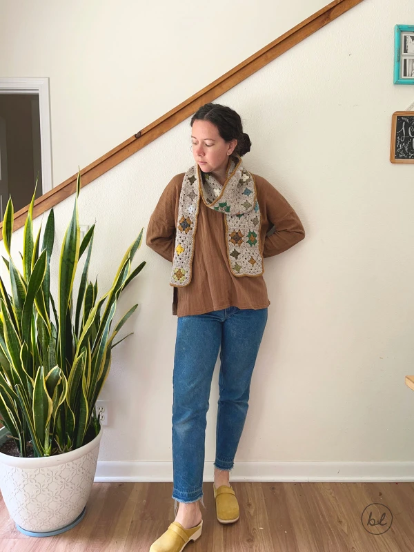 A granny square scarf made in muted tones.
