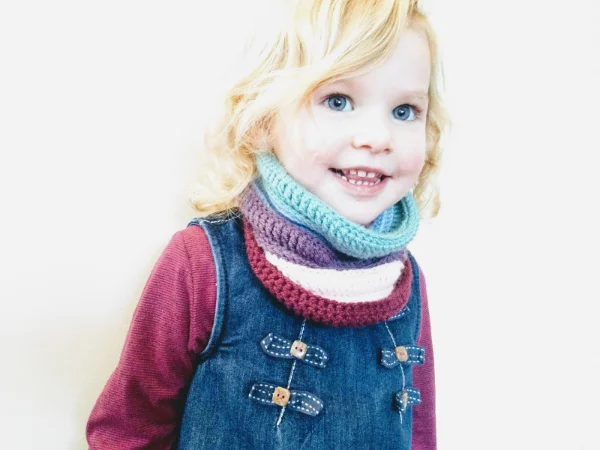 A child wearing a crochet infinity cowl.