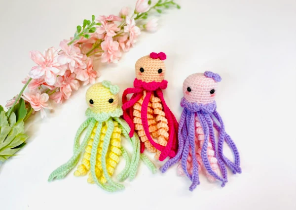 Three brightly coloured amigurumi jellyfish.