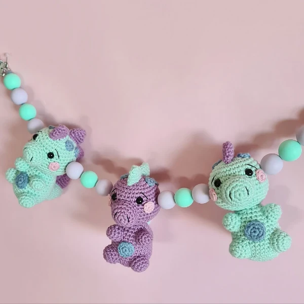 A crochet dinosaur pram chain,