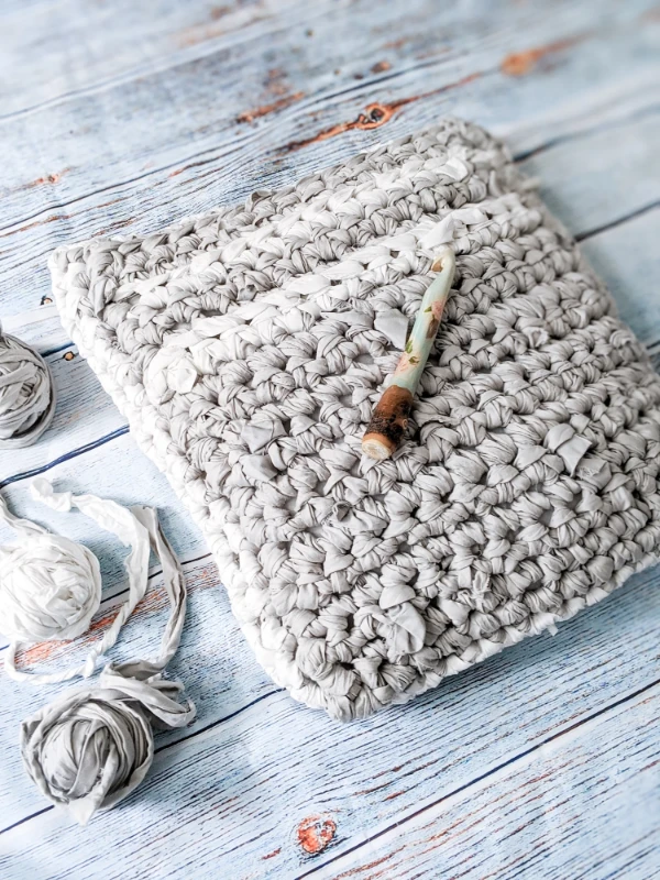 A crochet floor pillow made with DIY sheet yarn.