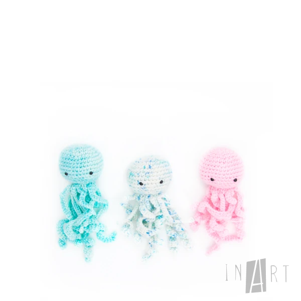 Three miniature crochet jellyfish toys in soft pastel colours.