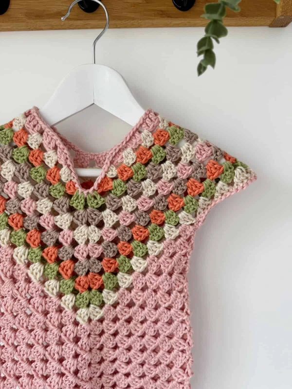 A v-neck granny stitch crochet child's dress.
