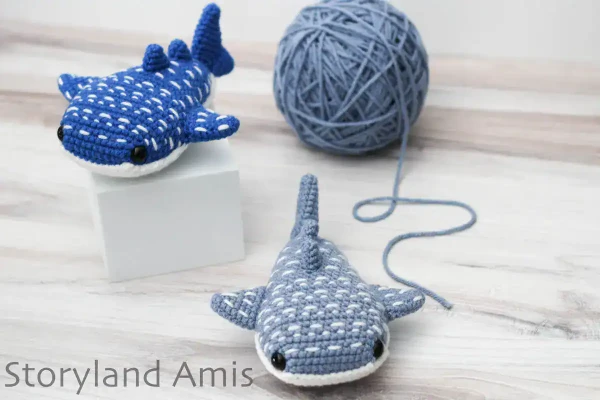 Two amigurumi whale shark crochet toys.