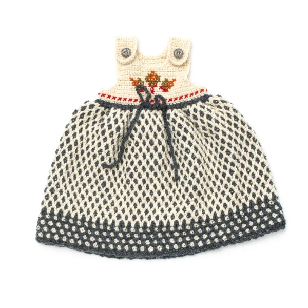 A crochet baby dress with an embroidered bodice.