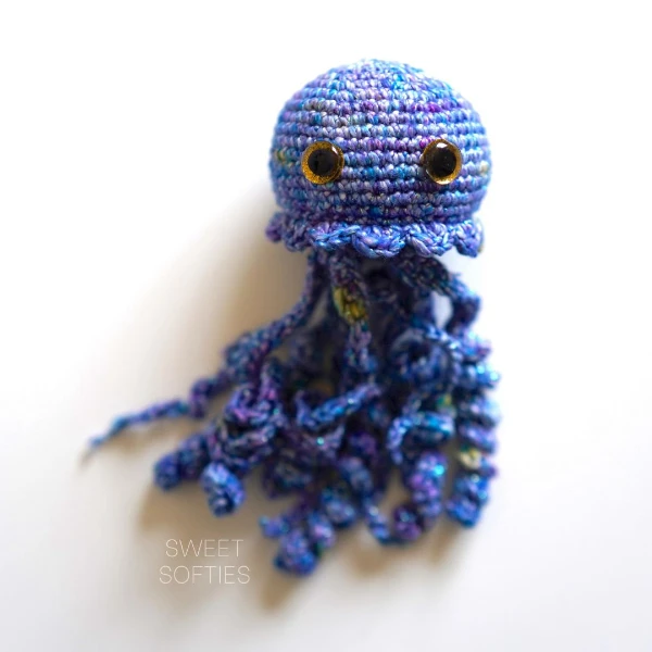 A crochet jellyfish toy made in self-striping yarn.