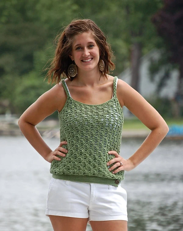 Woman wearing a green crochet tank top.