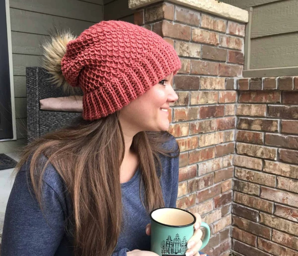 A woman wearing a crochet hat featuring Tunisian Honeycomb Stitch.