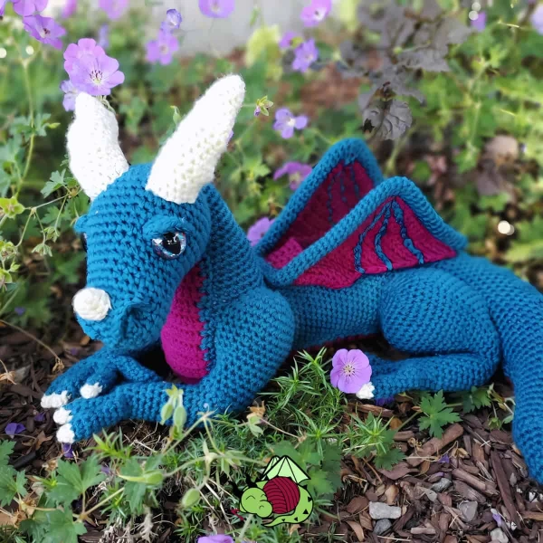 A large blue and pink amigurumi dragon.