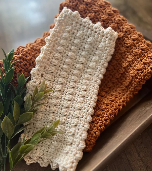 Crochet dishcloths with puffy berry stitch detail.