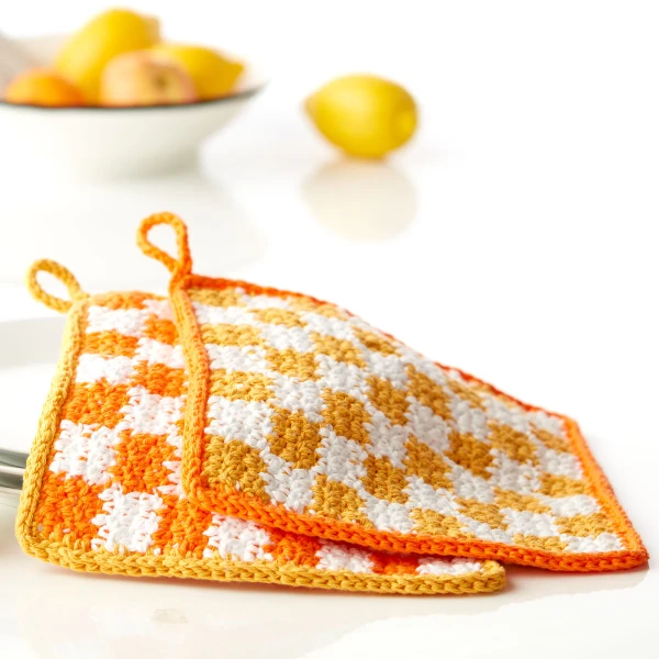Yellow and white checketed crochet dishcloths.