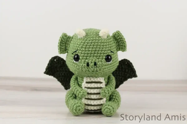 Green, mini crochet dragon toy.