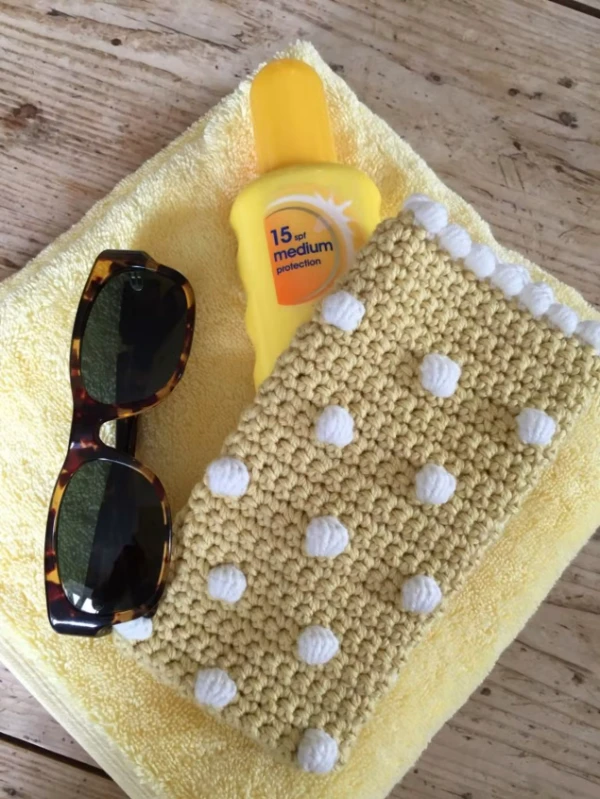 Lemon yeloow crochet glasses case with bobble stitch detail.