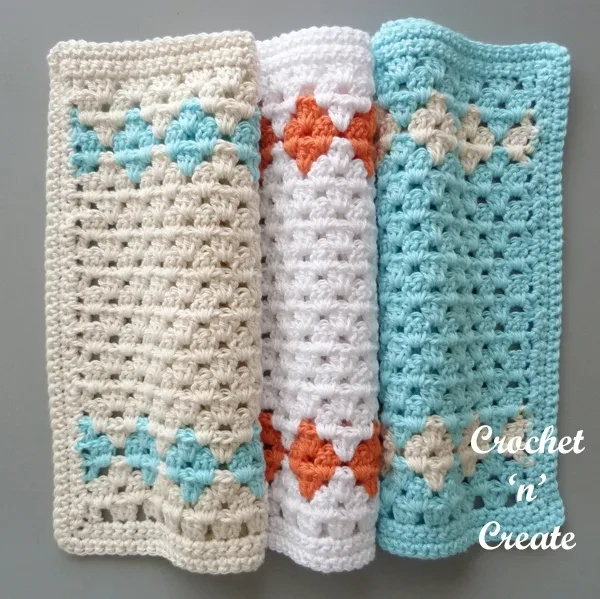 Three granny stitch dishcloths with diamond motifs.