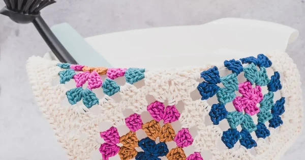 A crochet dishcloth made with granny squares.
