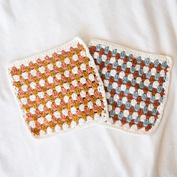 Two dishcloths worked in granny stripes.