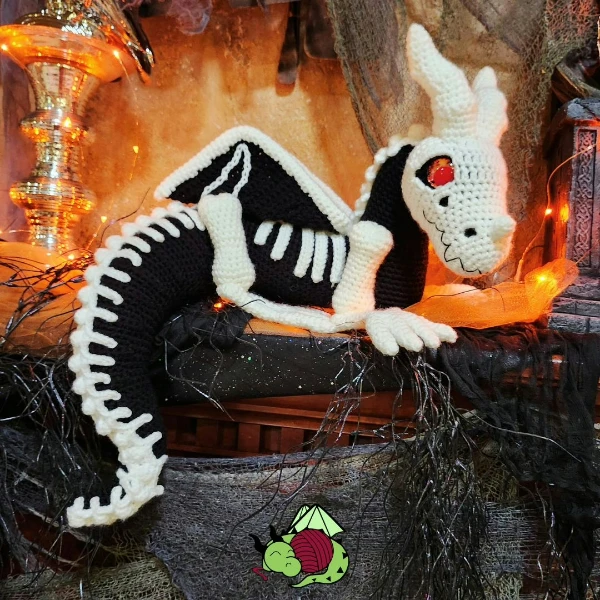A halloween-themed crochet dragon.