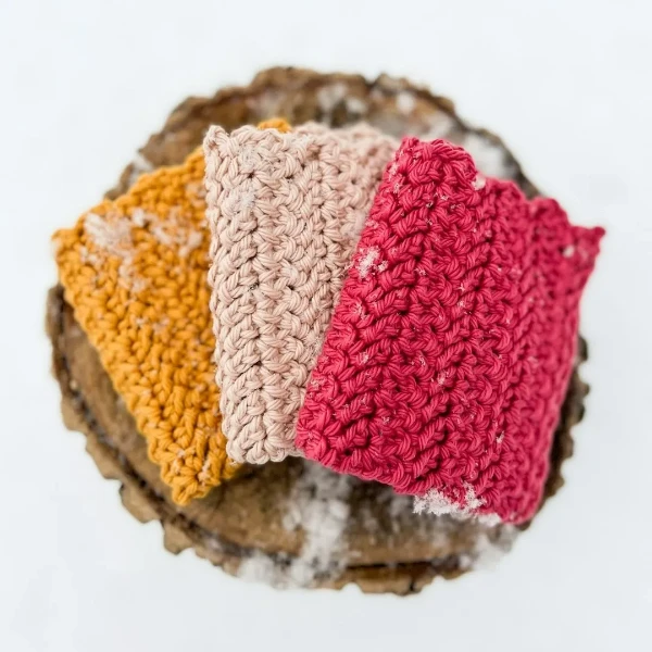 Three herringbone stitch crochet dishcloths in a basket.
