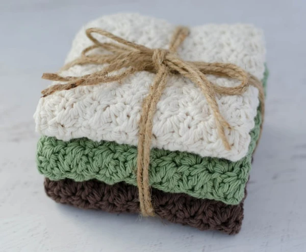 A stack of crochet dishcloths tied up with string.