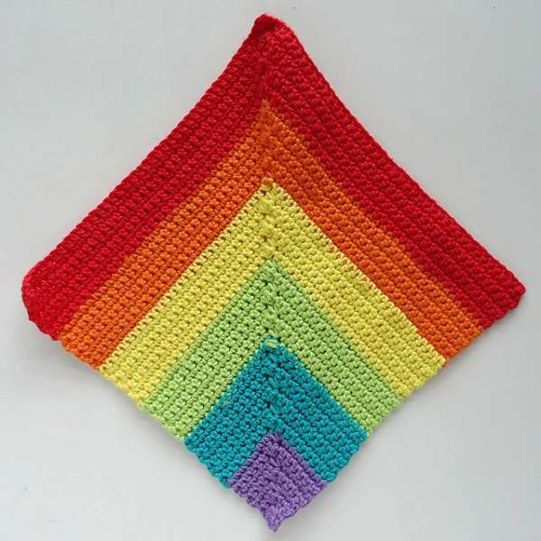 A mitred square crochet dishcloth made in rainbow colours.