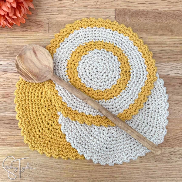 Yellow and white round crochet dishcloths.