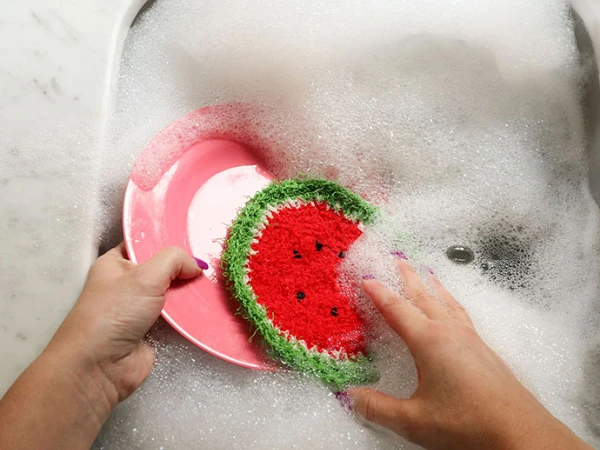 A crochet dishcloth made to resemble a slice of watermelon.