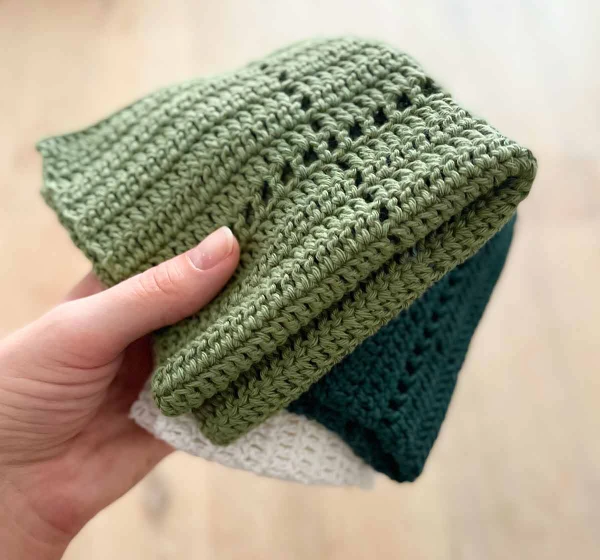 A green filet crochet dishcloth.