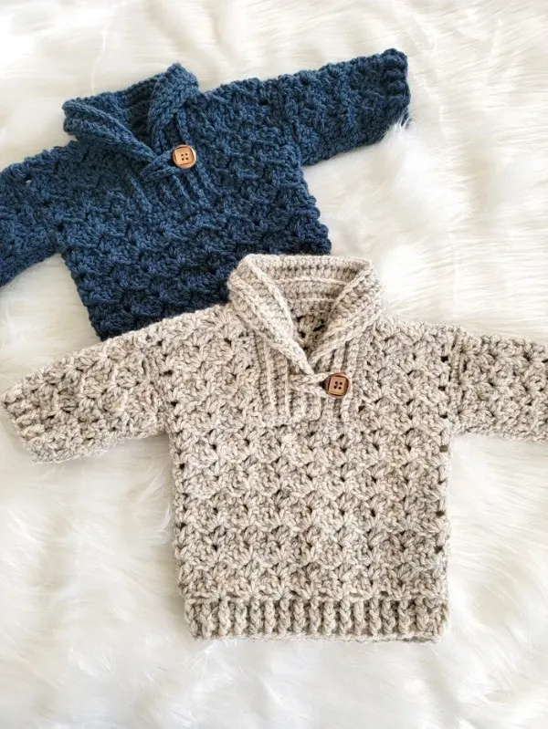 A flatlay image of child sized crochet sweaters with collars.