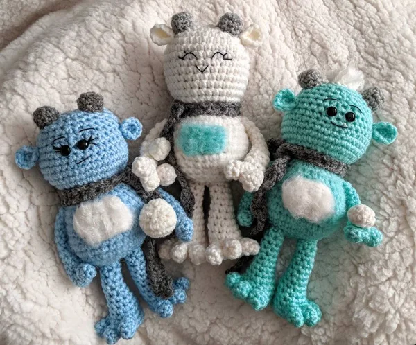 Three cute crochet big foot monsters.