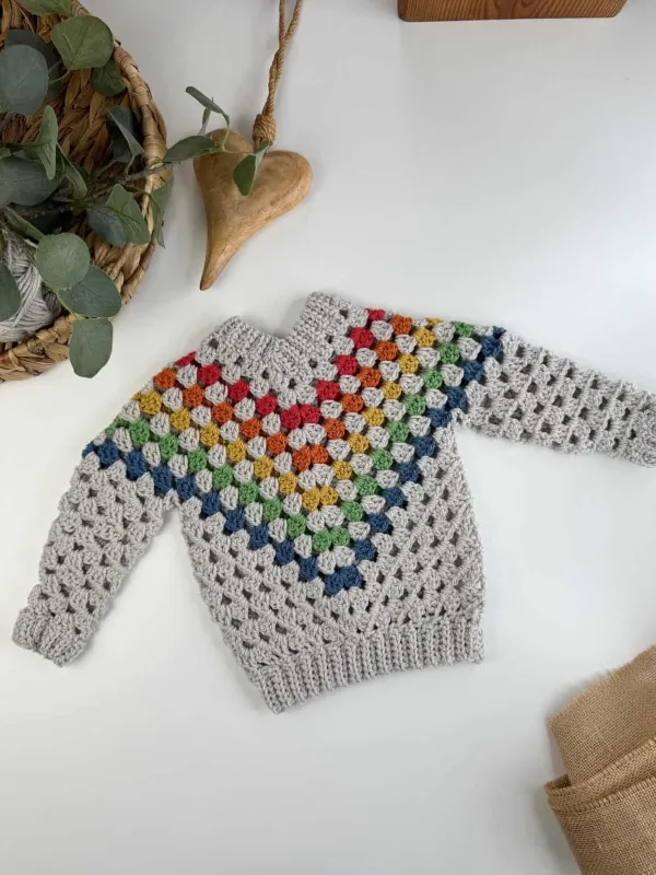 A kids' v-neck crochet sweater featuring the granny stitch.