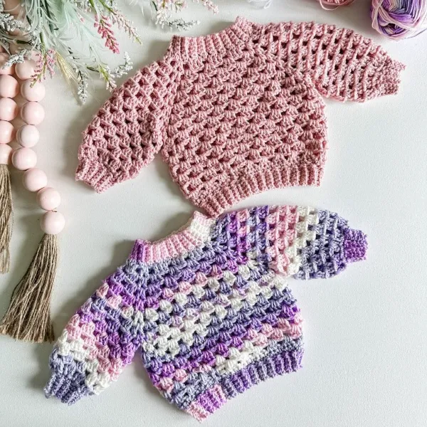 Two granny stitch kids' crochet sweaters.