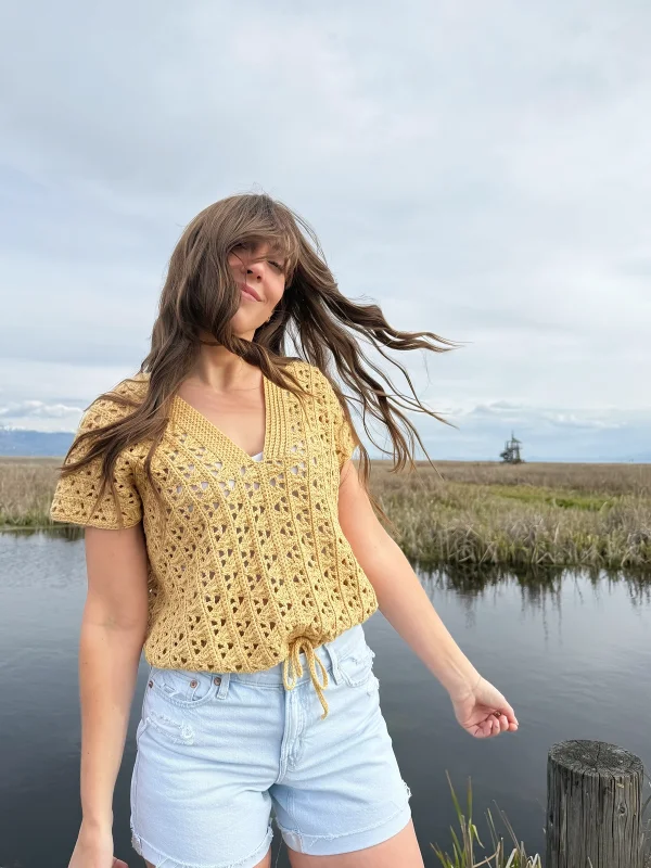 A lacy, yellow crochet tee with a drawstring waist.