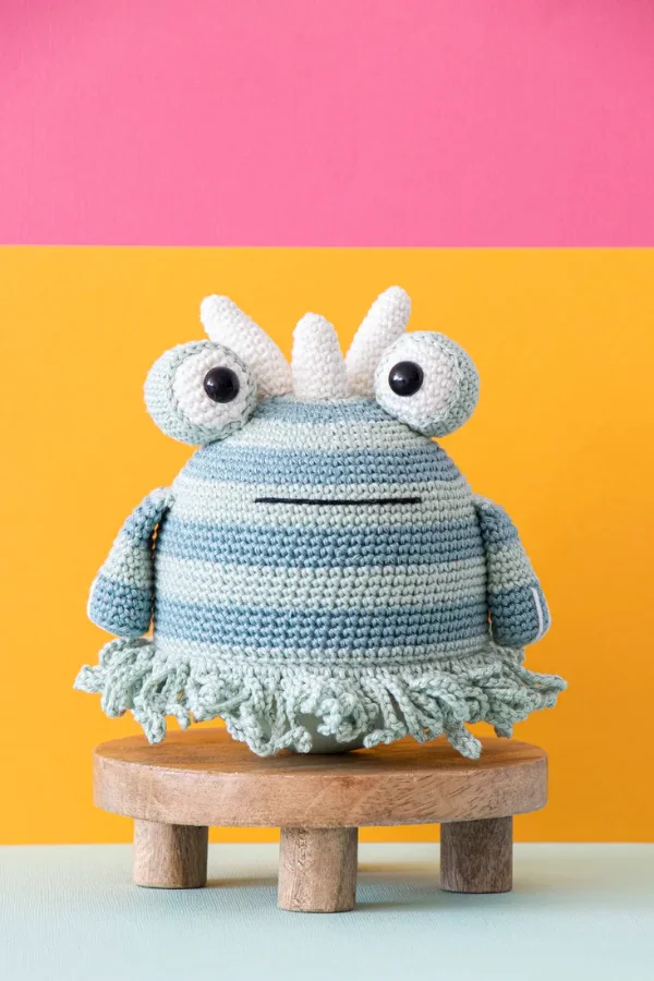 A cute striped crochet monster baby toy.